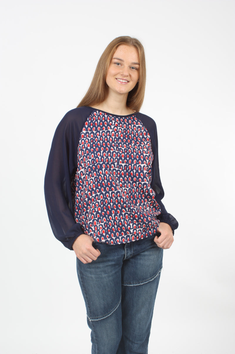 A women wearing a Chiffon Polyester top in Floral and Navy, elastic in the cuff.